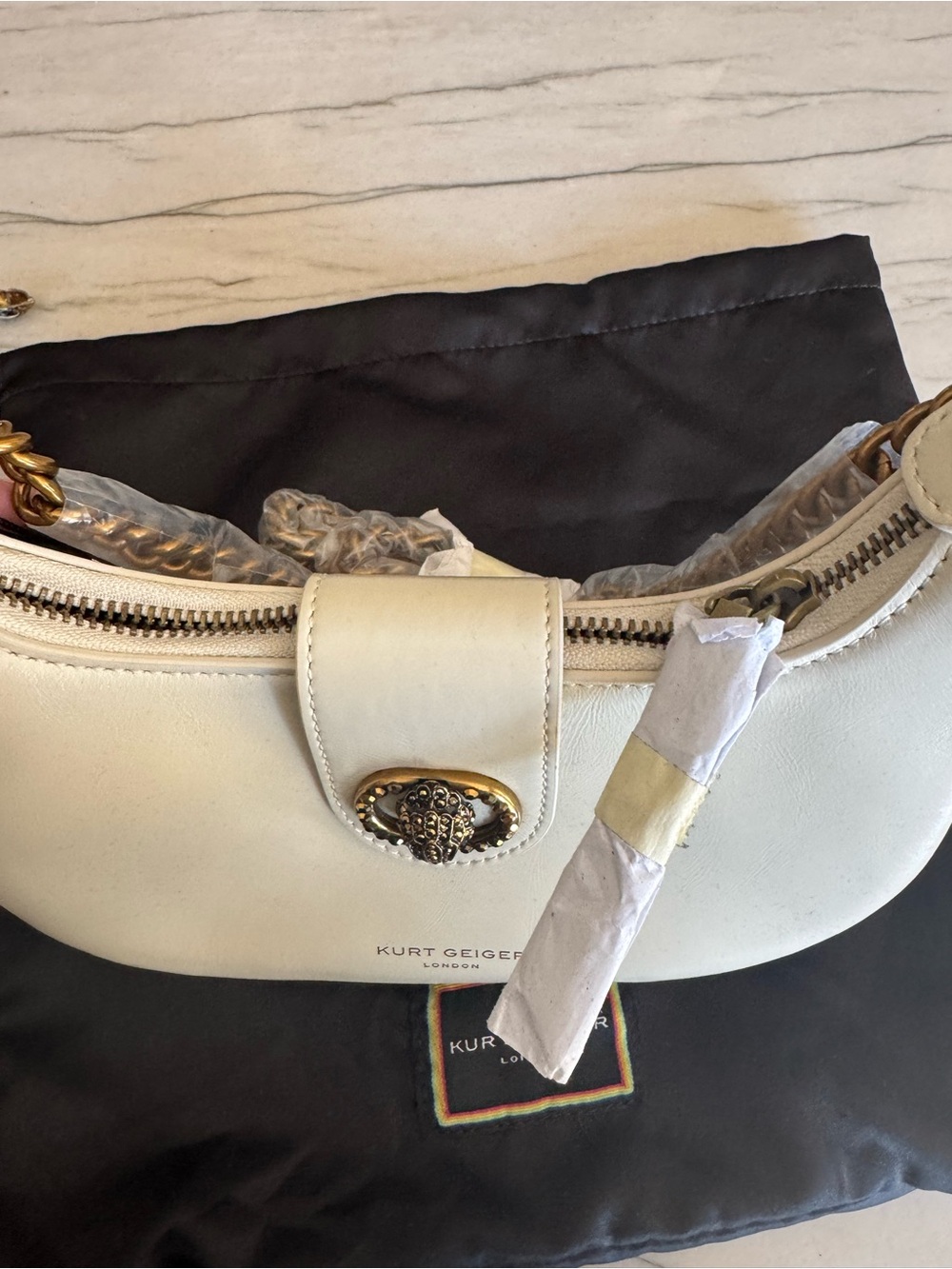 Kurt Geiger Cream Leather Crescent Shoulder Bag with Gold Emblem - Picture 2 of 2
